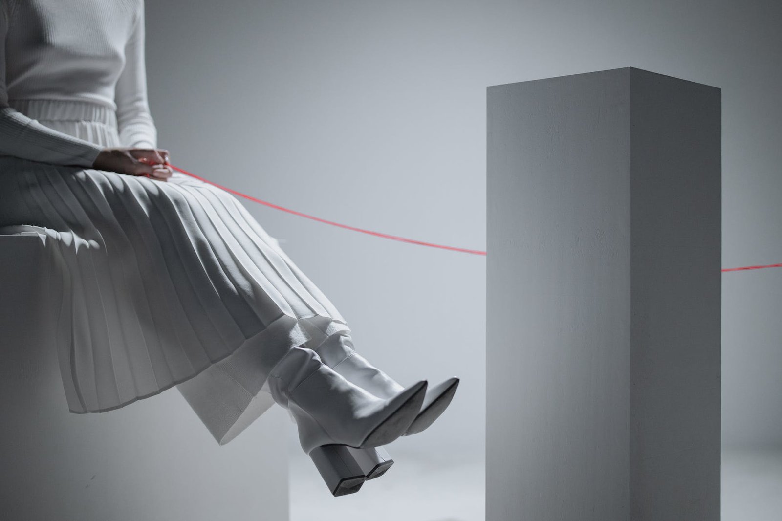 a woman holding a red thread